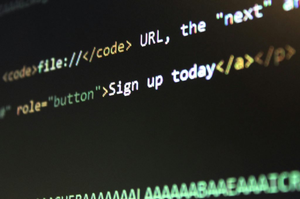Code on black computer screen showing text including sign up today